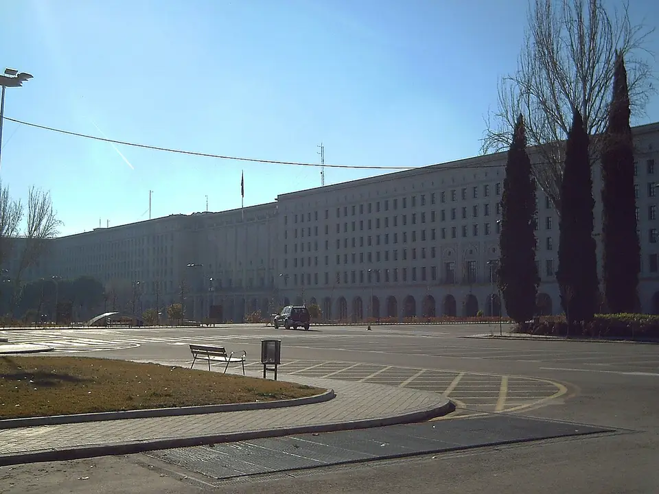 Nuevos Ministerios, a long government building with arcades on the Paseo de la Castellana in Madrid, under a clear sky